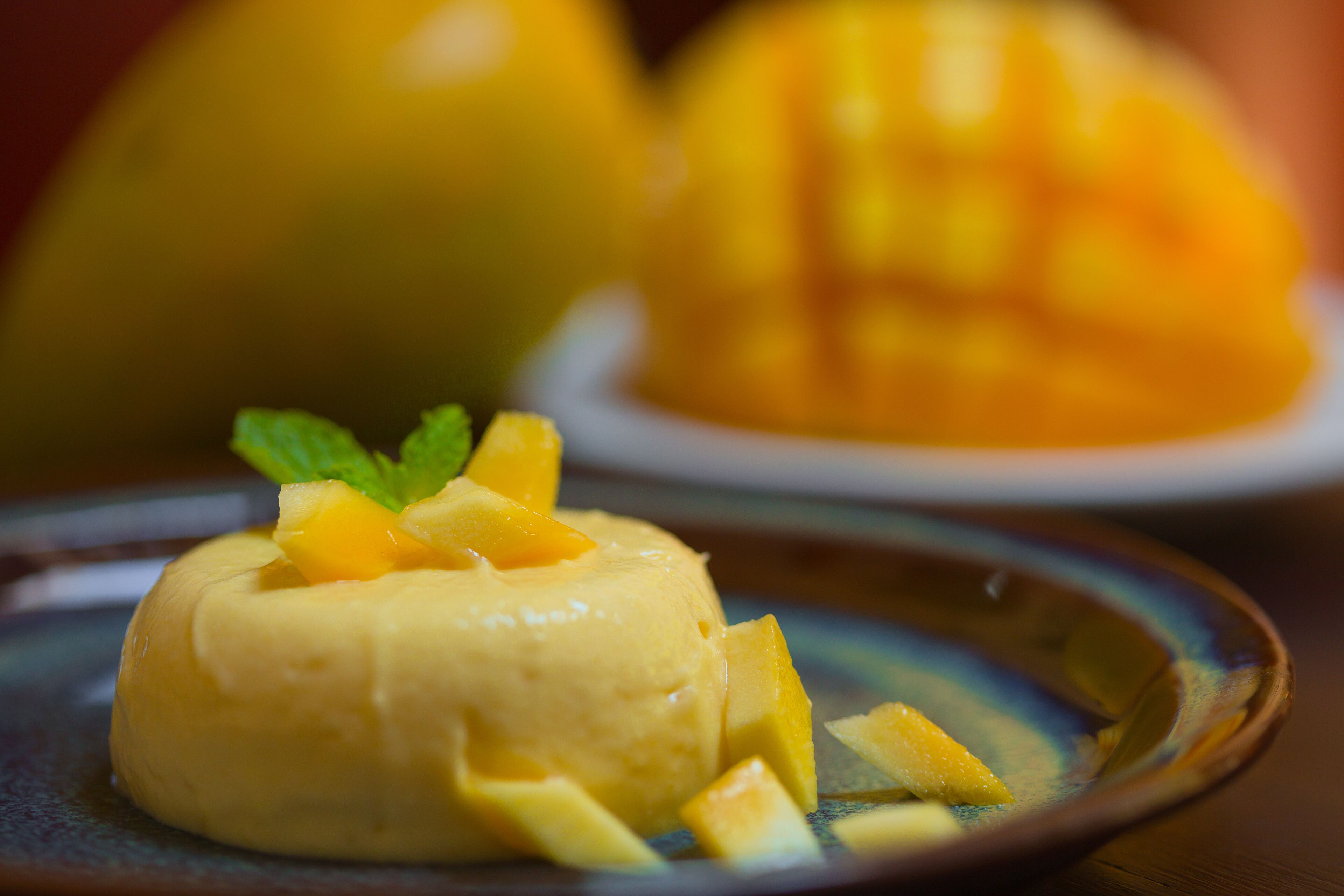 A dessert with mango chunks on a plate.