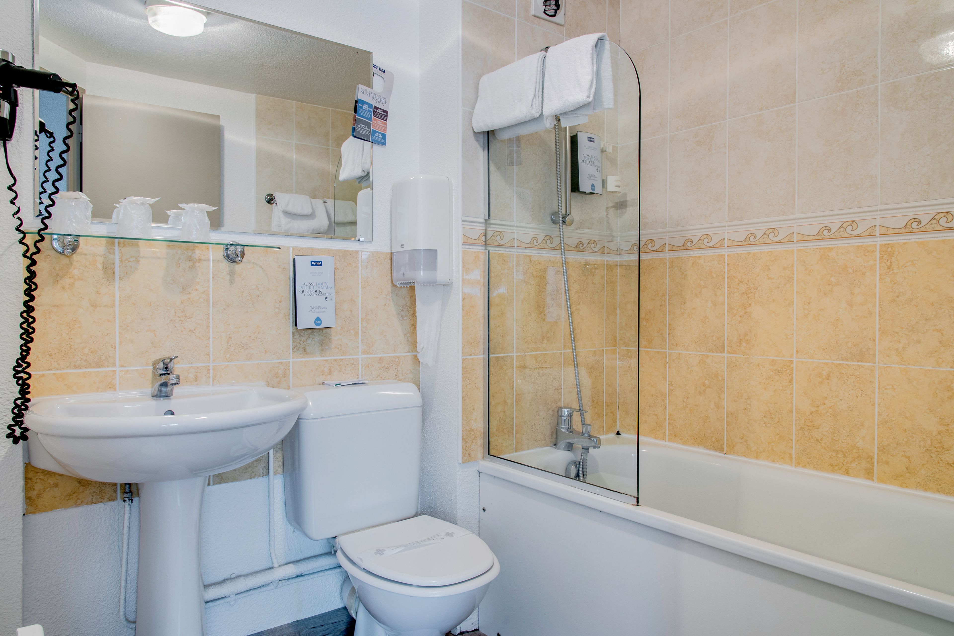 A bathroom with a sink, toilet, and bathtub.