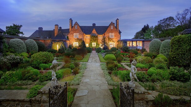 A large, historic house with a symmetrical garden and a central pathway leading to the entrance. - Greywalls Hotel and Chez Roux (Gullane)