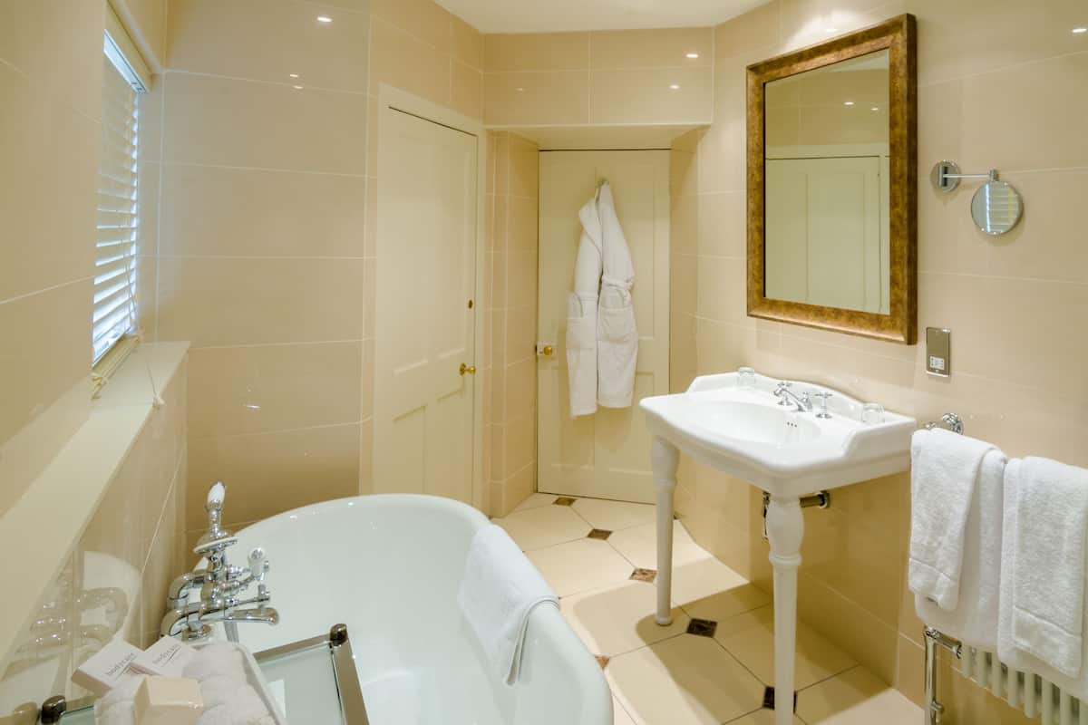 large main house room | bathroom | deep-soaking bathtub, free toiletries, hair dryer, bathrobes
