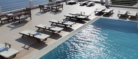 Seasonal outdoor pool, pool umbrellas, pool loungers