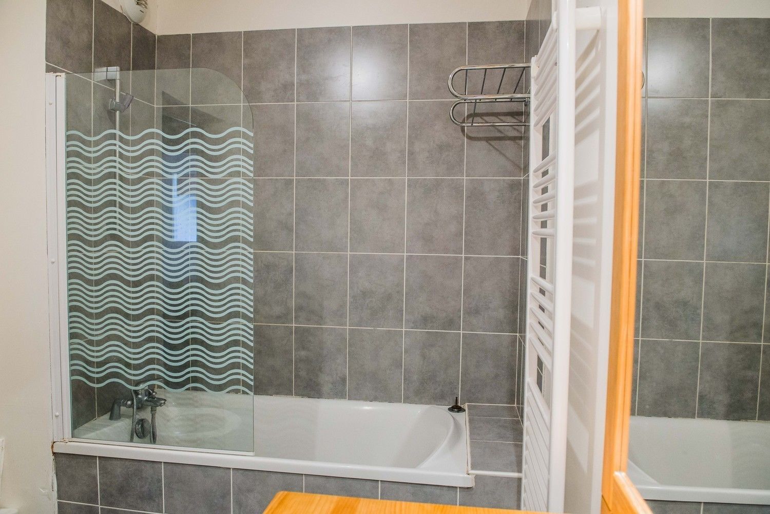 A bathroom with a shower, a bathtub, and a toilet.