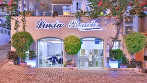 A boutique hotel named "Linda Beach" with a modern facade, large glass windows, and lush greenery. - Linda Beach Class Hotel - Boutique Class (Kas)