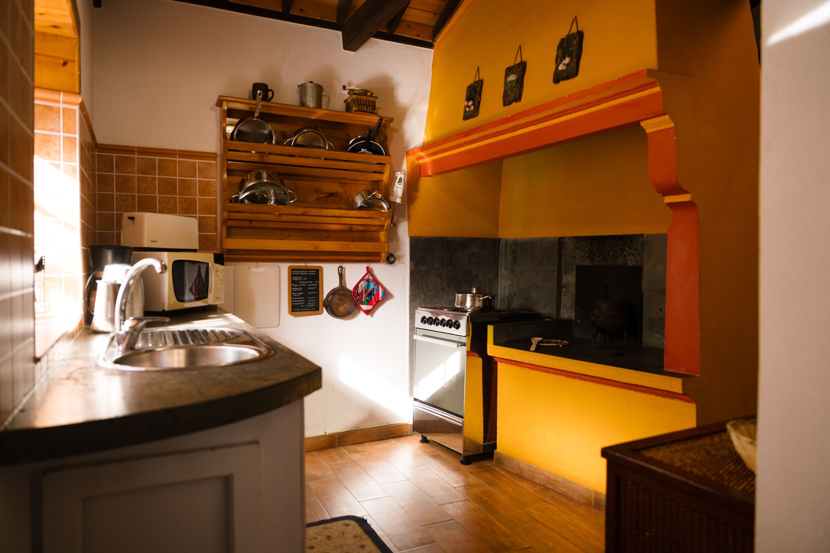 A kitchen with a stove, oven, and various kitchen utensils.