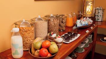 A breakfast buffet with various food items and beverages.