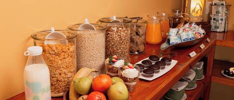 A breakfast buffet with various food items and beverages.