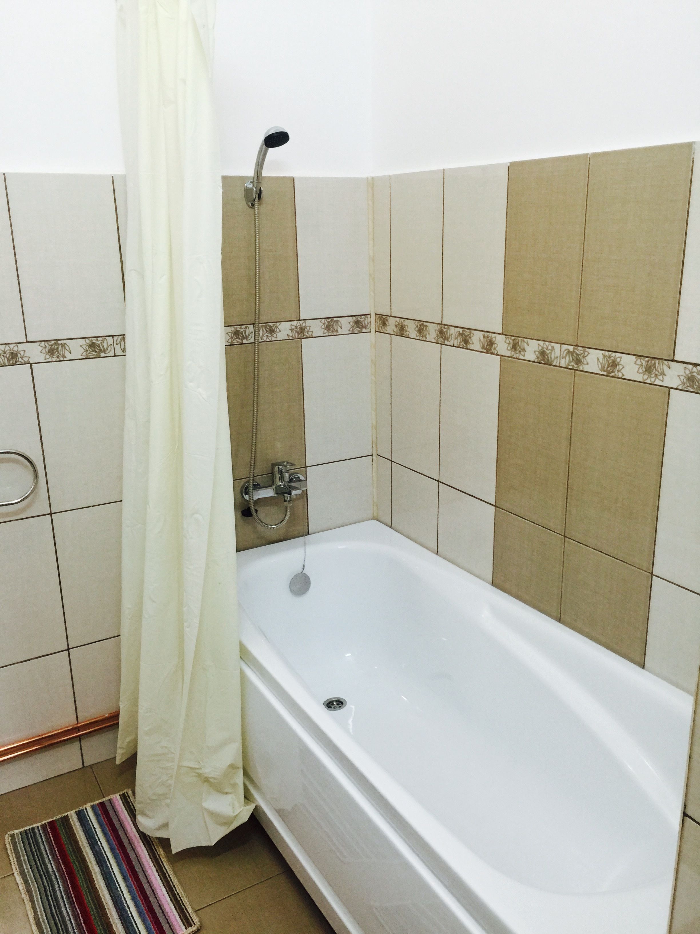 A bathroom with a bathtub, a shower, and a toilet.