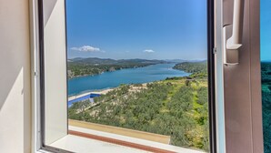 A view from a balcony overlooking a lake with mountains in the distance. - Hotel Panorama (Sibenik)