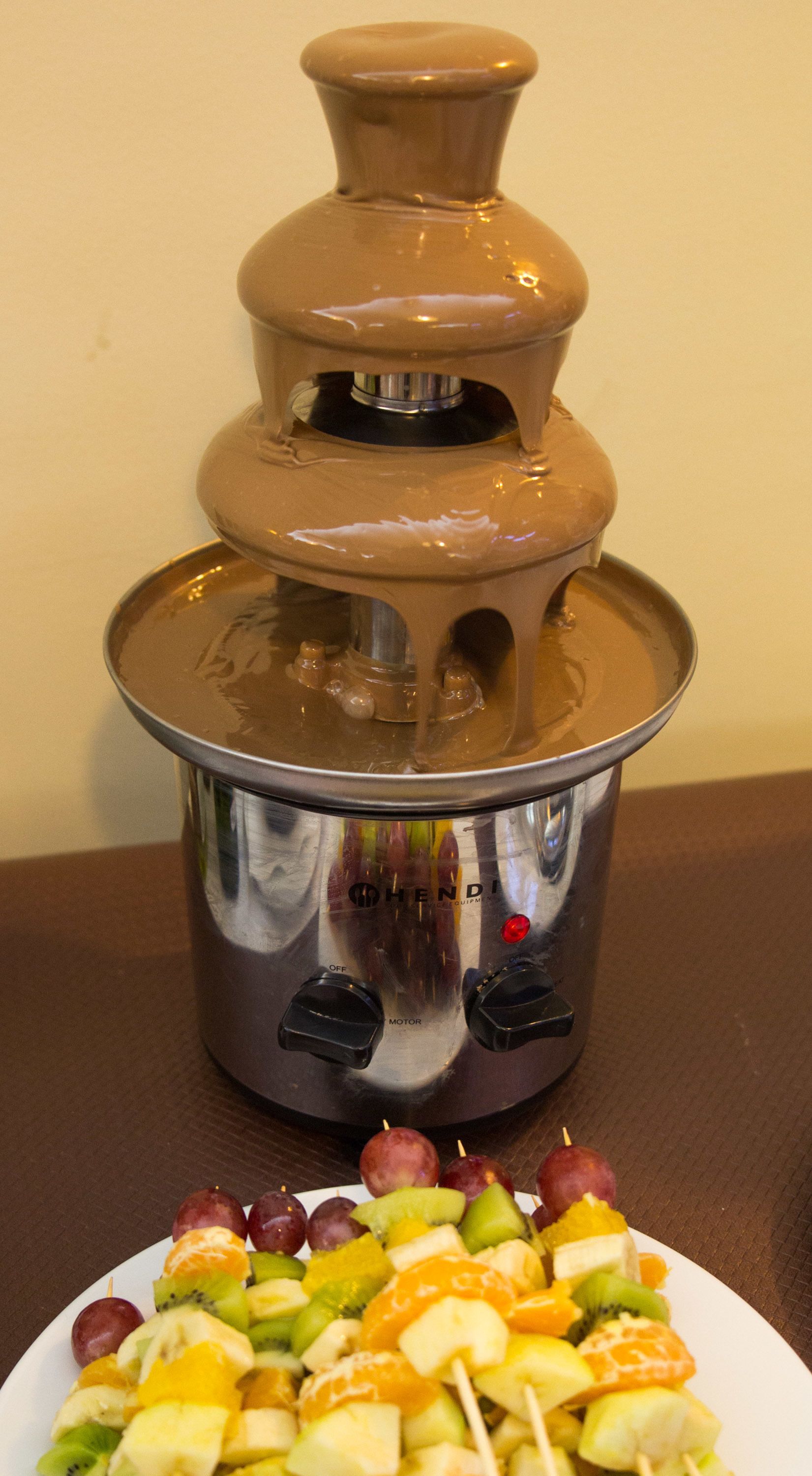 A fondue set with a pot and a smaller pot on a table.