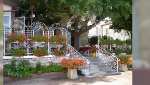 A stone staircase with metal railings leading to a covered porch. - La Table d'Antan (Bon-Encontre)