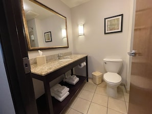 A bathroom with a sink, mirror, toilet, and a towel rack. - Comfort Suites Altoona North (Altoona)