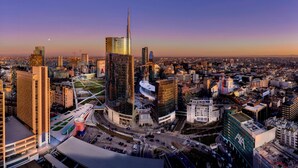 A cityscape with modern high-rise buildings, a prominent skyscraper, and a mix of commercial and residential structures. - Holiday Inn Milan Nord Zara by IHG (Cinisello Balsamo)