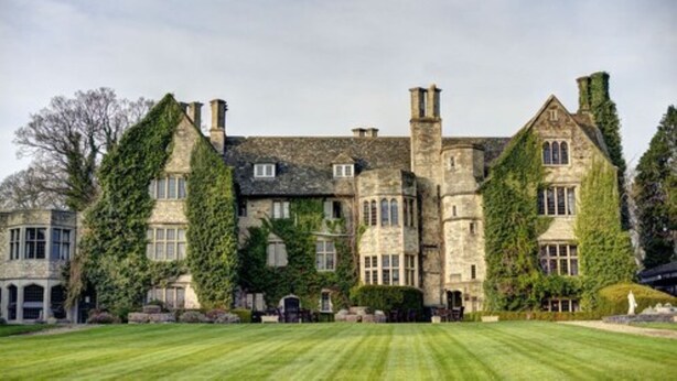 A large stone building with multiple chimneys and ivy-covered walls. - Stonehouse Court Hotel (Stonehouse)