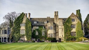 A large stone building with multiple chimneys and ivy-covered walls. - Stonehouse Court Hotel (Stonehouse)
