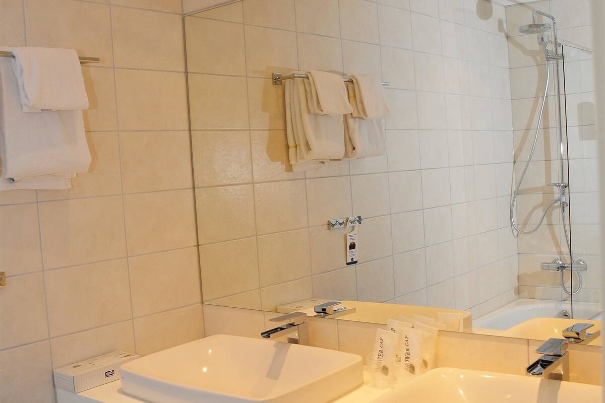 suite, 1 double bed, non smoking, balcony (living room) | bathroom | shower, hair dryer, heated floors, towels
