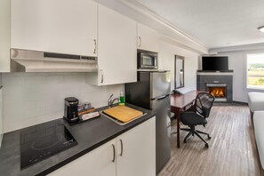 A compact kitchen with a microwave, refrigerator, and coffee maker. - Quality Inn & Suites Whitecourt (Whitecourt)