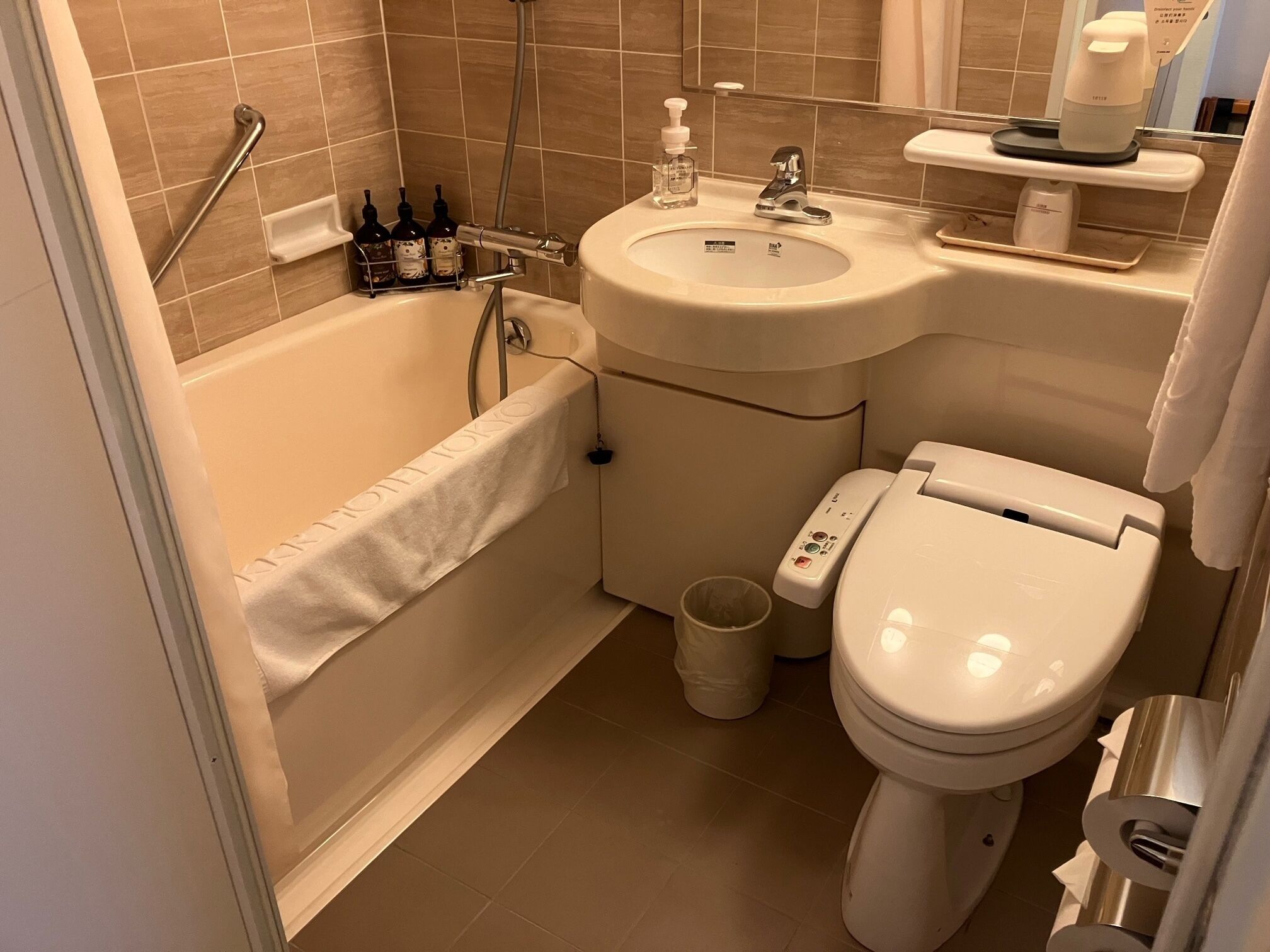 A bathroom with a bathtub, toilet, and sink.