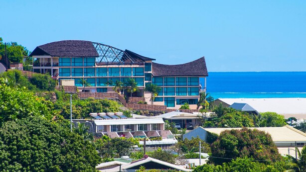 A multi-story building with a modern architectural design, featuring a prominent sloped roof and large windows. - Tahiti Airport Motel (Faaa)