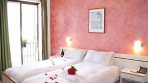 A hotel room with two beds, a balcony, and a painting on the wall. - Stella D'Oro (Tremosine)