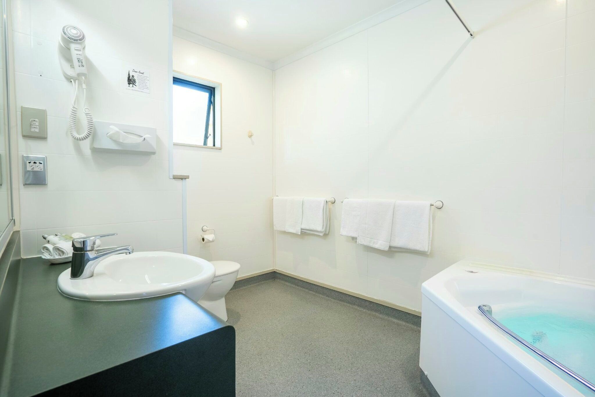 A bathroom with a sink, toilet, and bathtub.