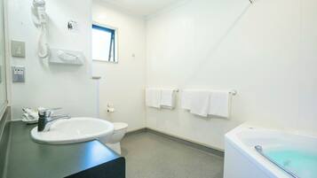 A bathroom with a sink, toilet, and bathtub.