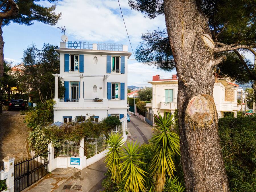 A two-story building with a sign reading "HOTEL ALBERT".