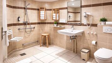 A modern bathroom with a shower, toilet, sink, and a mirror.