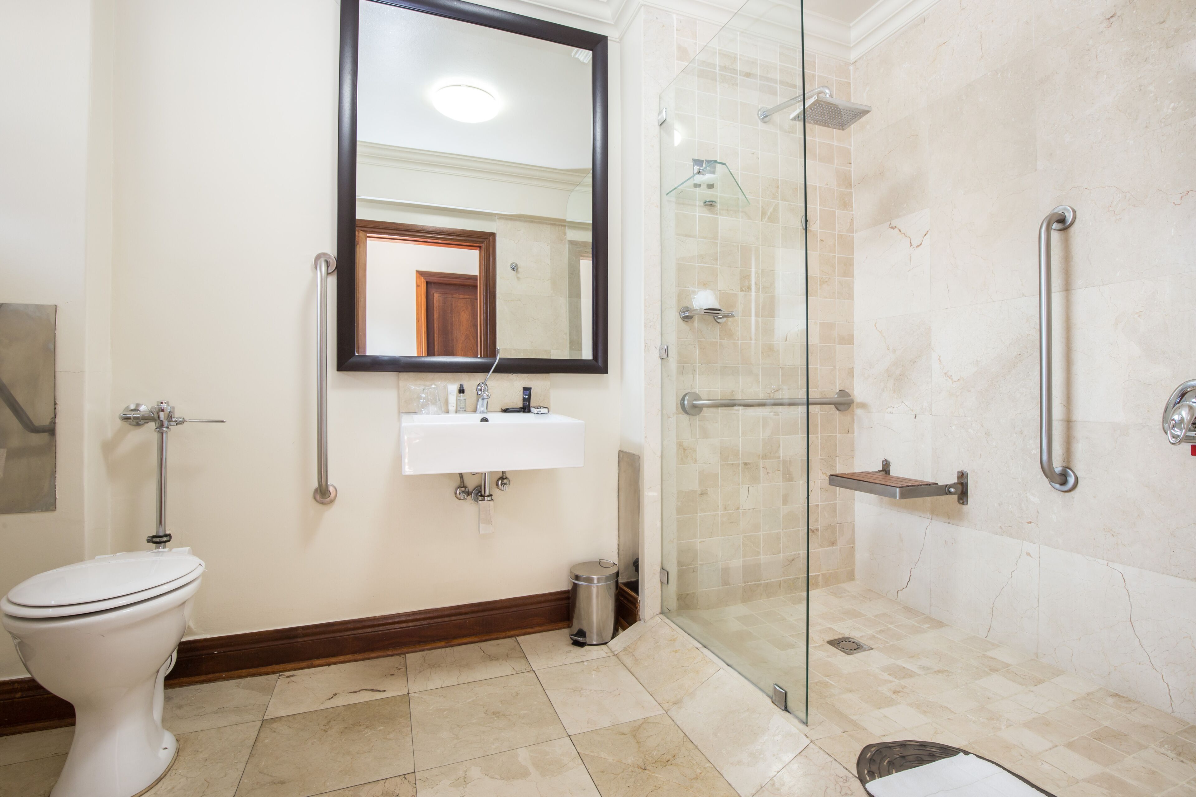 A bathroom with a toilet, sink, and shower area.