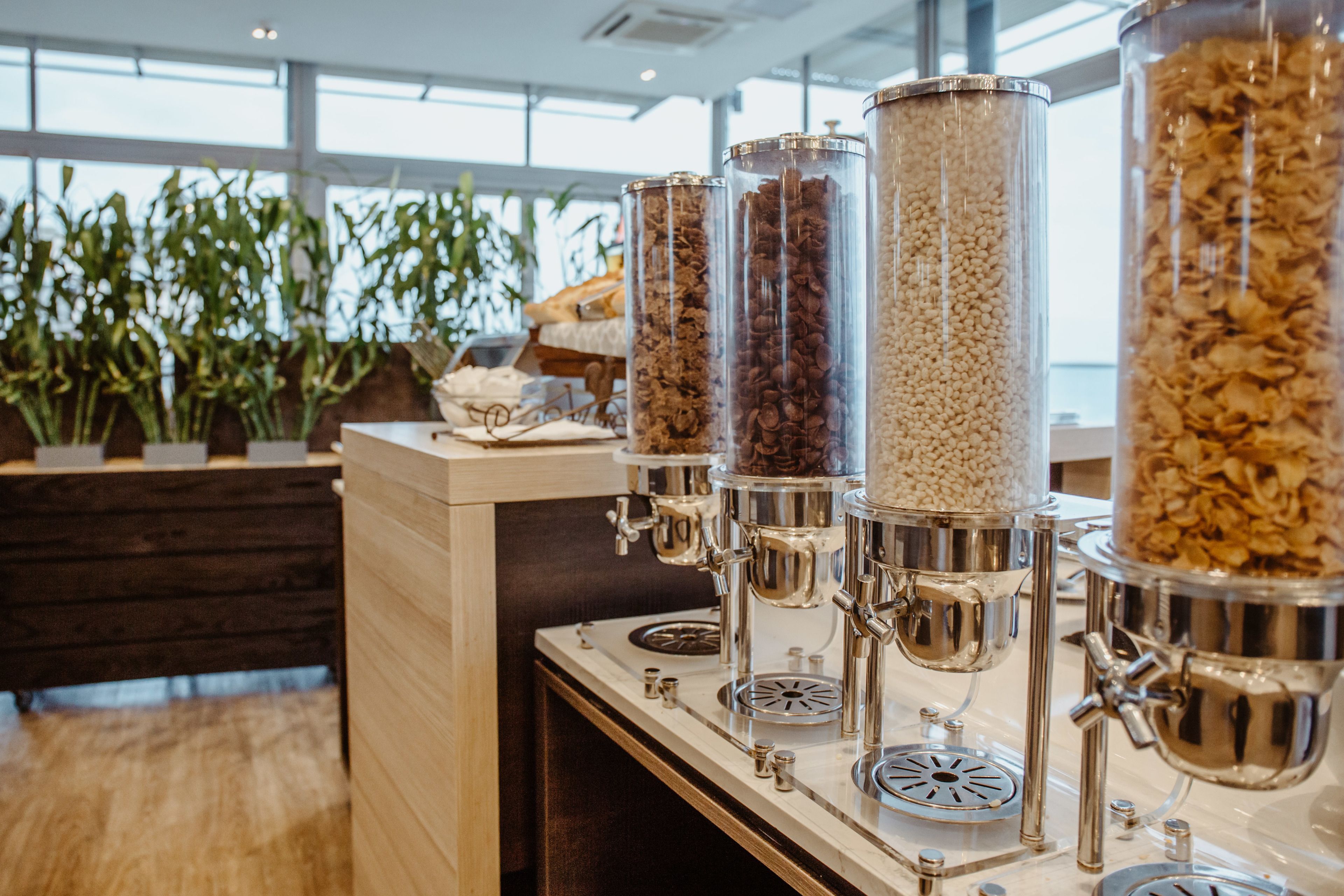 A coffee station with multiple dispensers filled with different types of coffee beans.