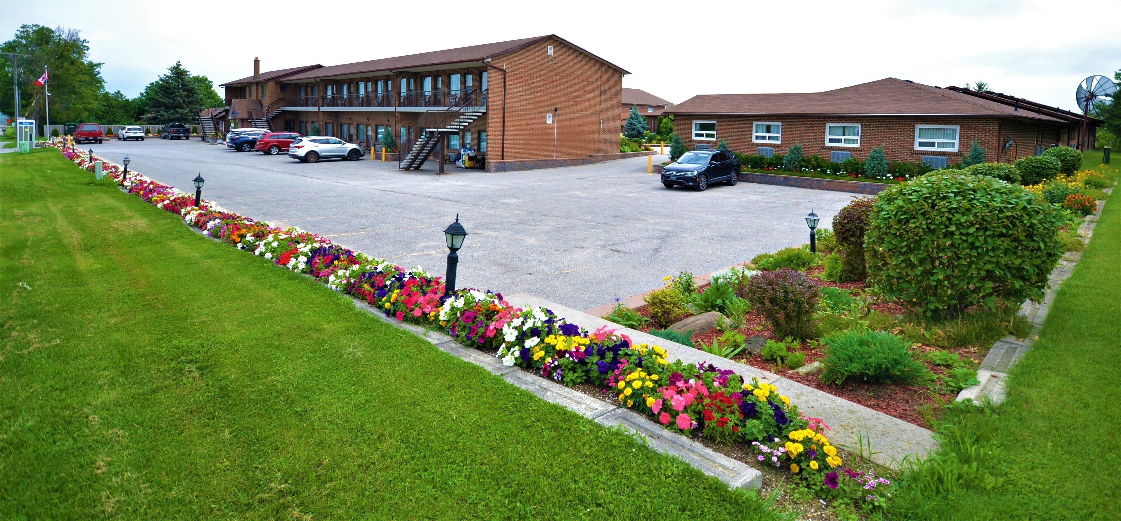 A parking lot with a building that has a brick facade and a flat roof.