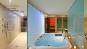 Un moderno cuarto de spa con hidromasaje, paredes de vidrio y un área de relajación con sillones.