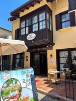 The exterior of Villa DanLin Hotel with a sign advertising a calm and relaxing patio.