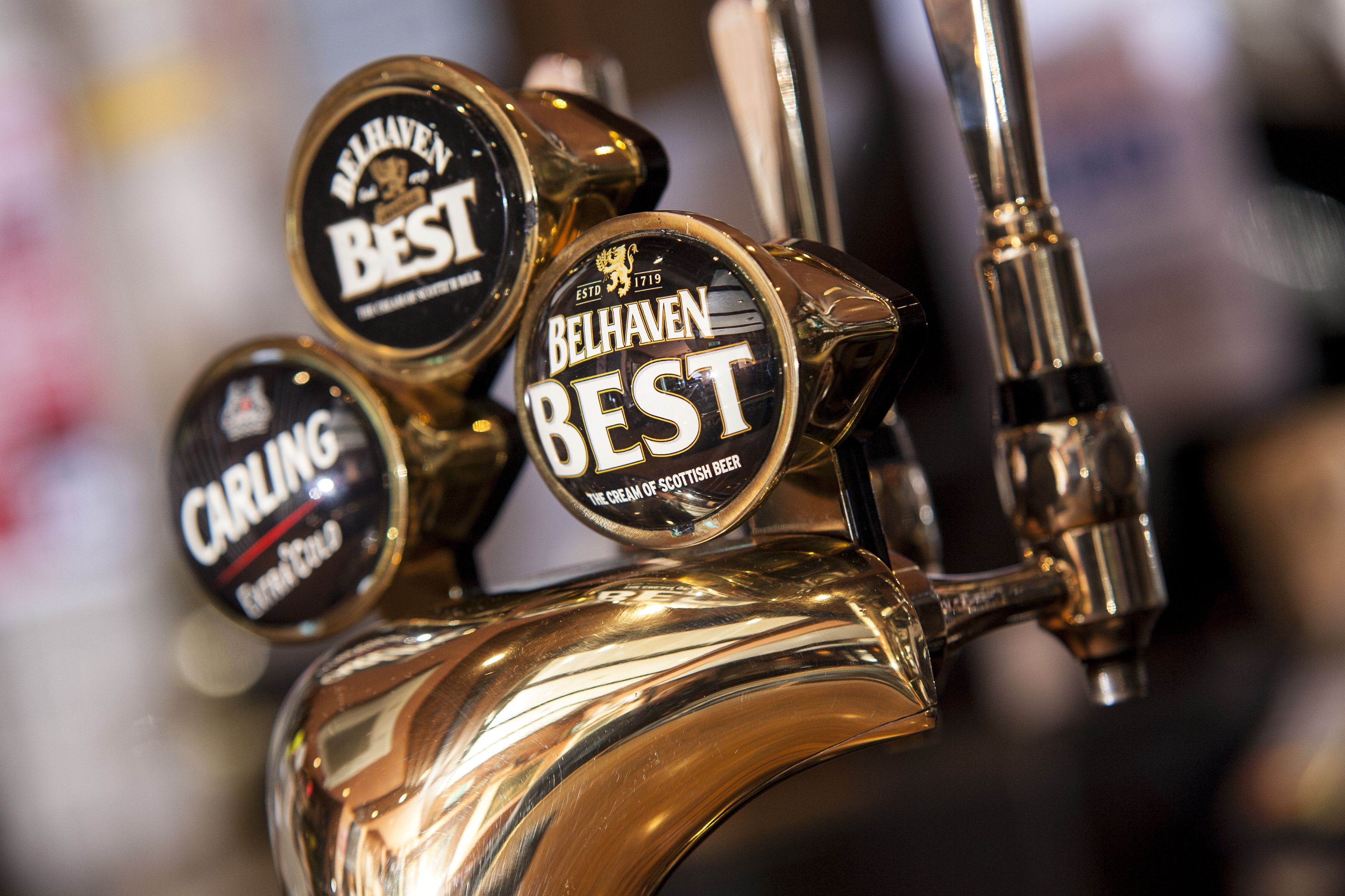 A tap with three beer labels: Belhaven Best, Carling, and another Belhaven Best.