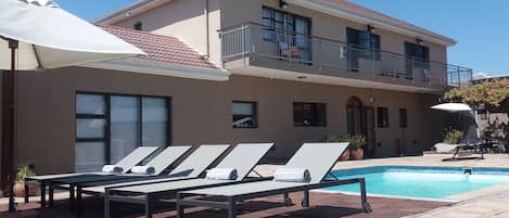 Outdoor pool, pool umbrellas, pool loungers