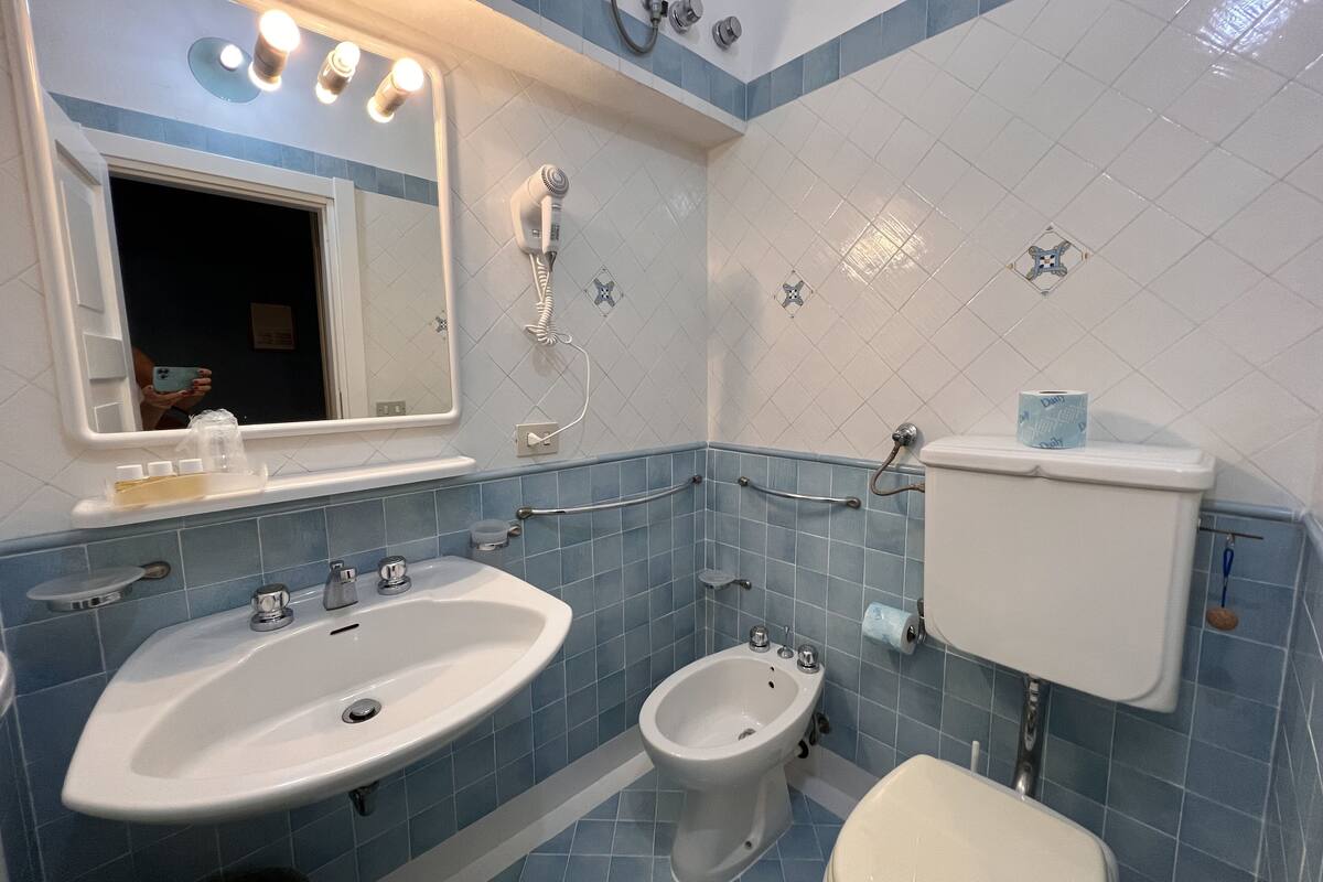 economy triple room, multiple beds | bathroom | shower, hair dryer, towels