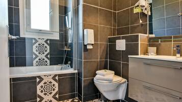 A modern bathroom with a shower, toilet, and vanity.