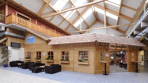 A wooden cabin-style building with a sloped roof, wooden railings, and a sign reading "Gleitschieber Stuben".