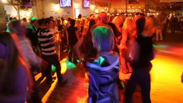 A crowded indoor space with people standing and interacting.