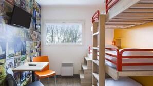 A compact room with a bunk bed, a desk with a chair, a window with a view of trees, and a wall decorated with travel posters. - hotelF1 Maurepas (Maurepas)