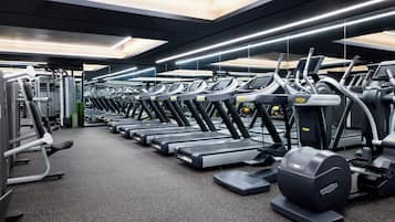 A gym with multiple treadmills and weight machines.