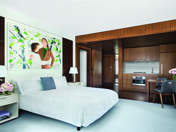 A modern hotel room with a large bed, a desk, and a dining area. - The Langham, New York, Fifth Avenue (New York)