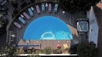 Outdoor pool, open 10:00 AM to 8:00 PM, pool umbrellas, pool loungers