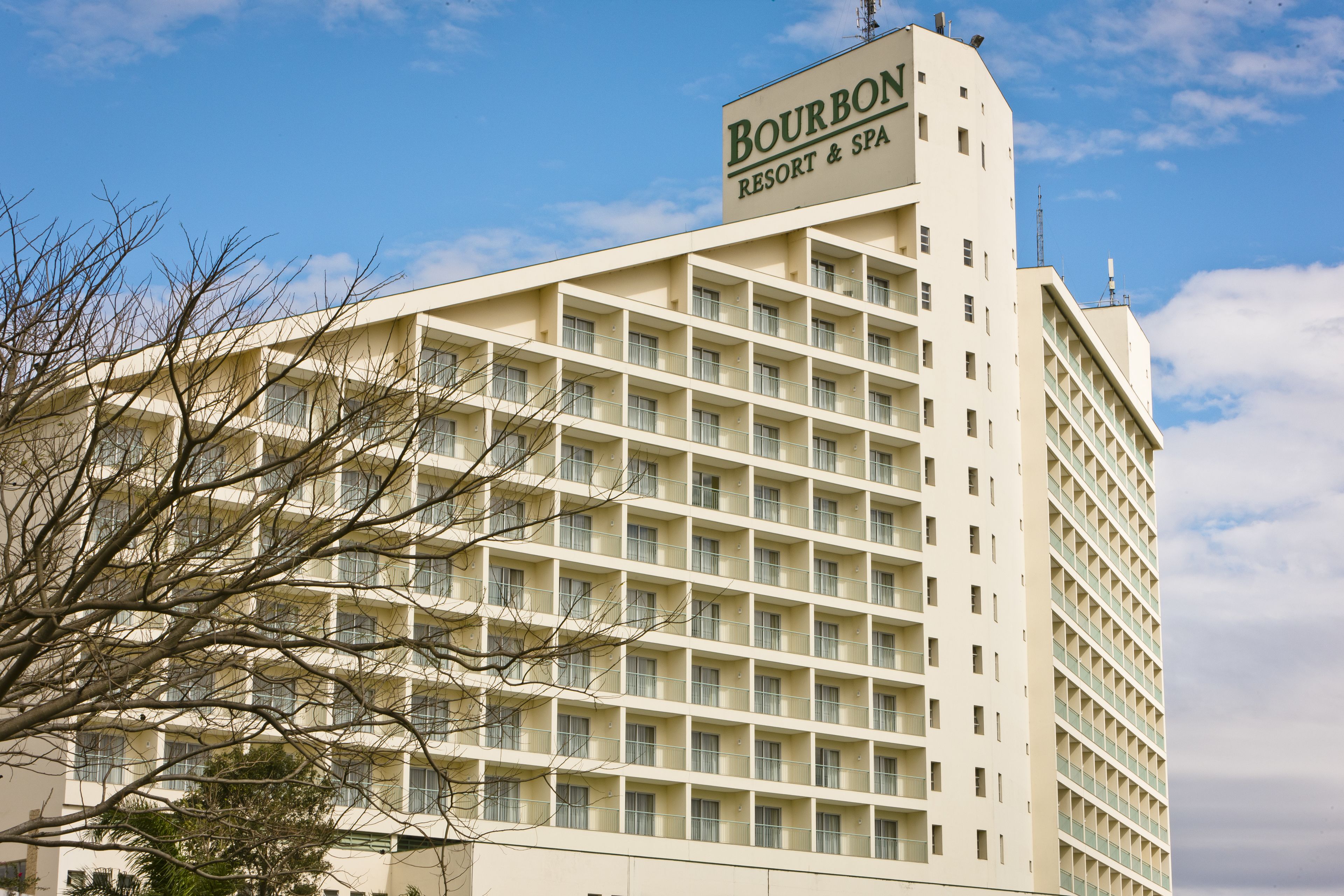 A high-rise hotel with a sign reading "Bourbon Resort & Spa".