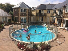 Seasonal outdoor pool, open 9 AM to 7:00 PM, pool umbrellas