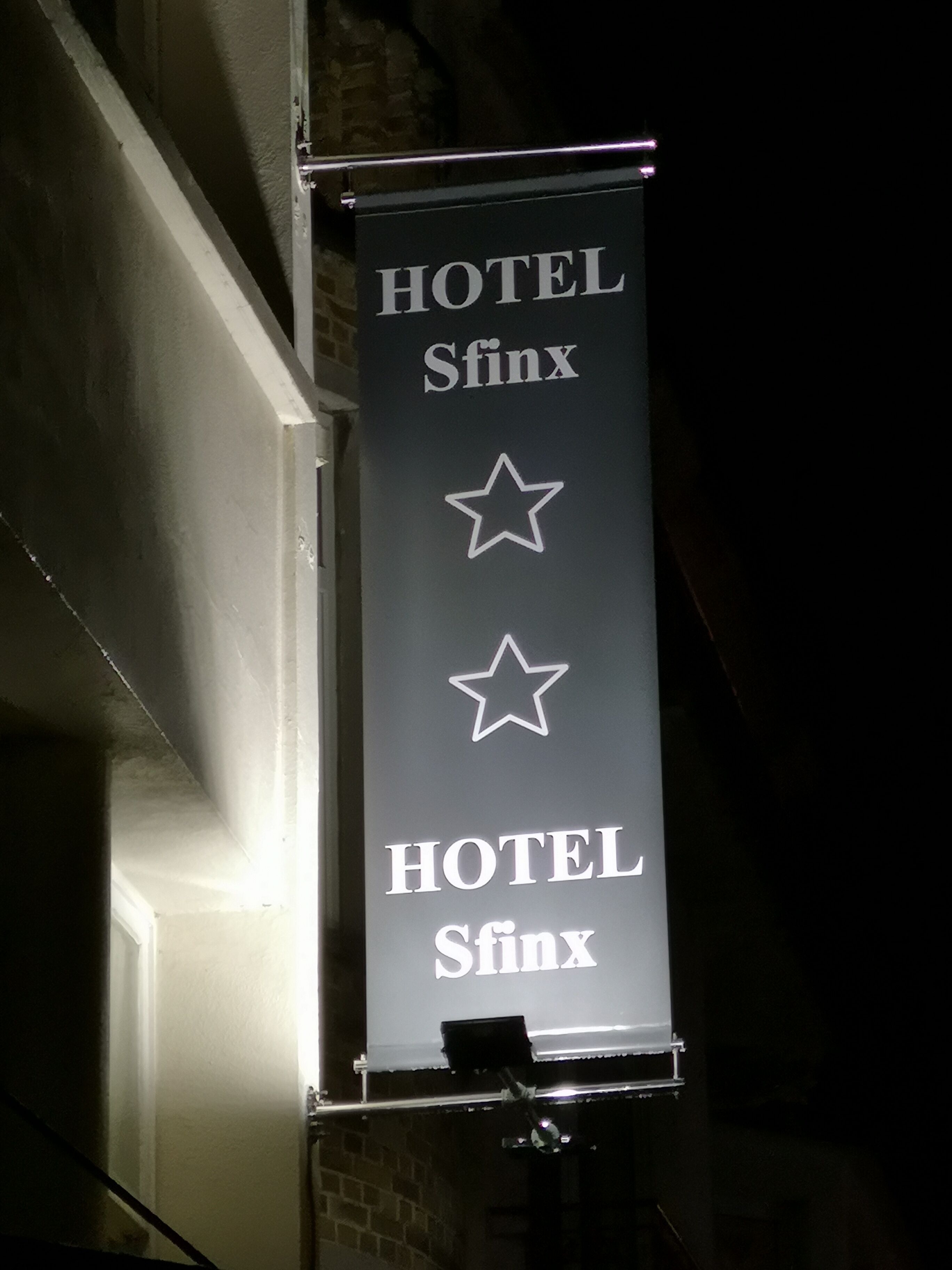 A banner with the text "HOTEL Sfinx" and two stars, indicating the hotel's name and possibly its rating.