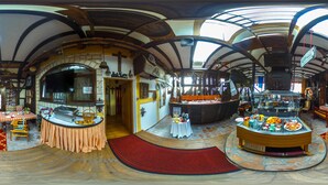 A circular room with a central bar area, a dining table with chairs, and a buffet counter. - Hotel Garten (Slavonski Brod)