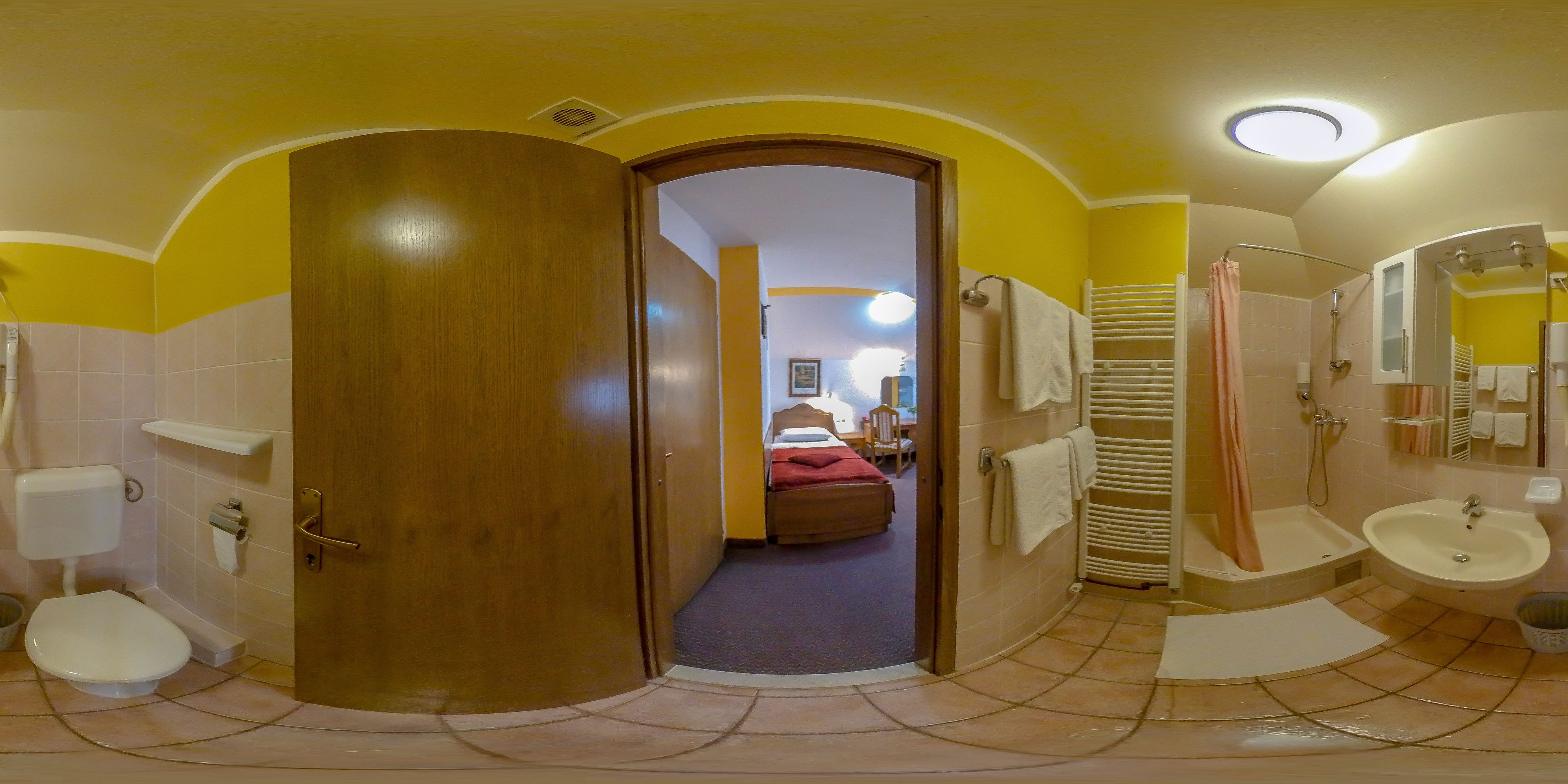 A bathroom with a shower, sink, and toilet.