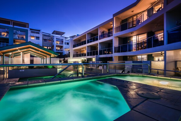 A hotel with a swimming pool, multiple balconies, and a covered area with a roof. - Coolum Seaside (Coolum Beach)
