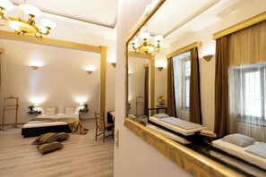 A hotel room with a large bed, a desk, a chair, and a mirror. - Friends Hostel and Apartments Budapest (Budapest)