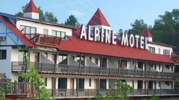 A two-story building with a red roof and balconies, labeled "AERINE MOTEL".
